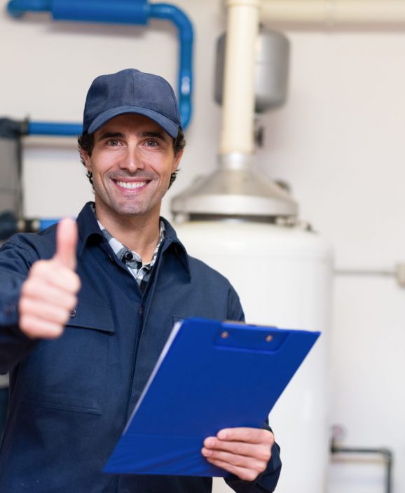 Smiling plumber at work Smiling technician servicing a hot-water heater
